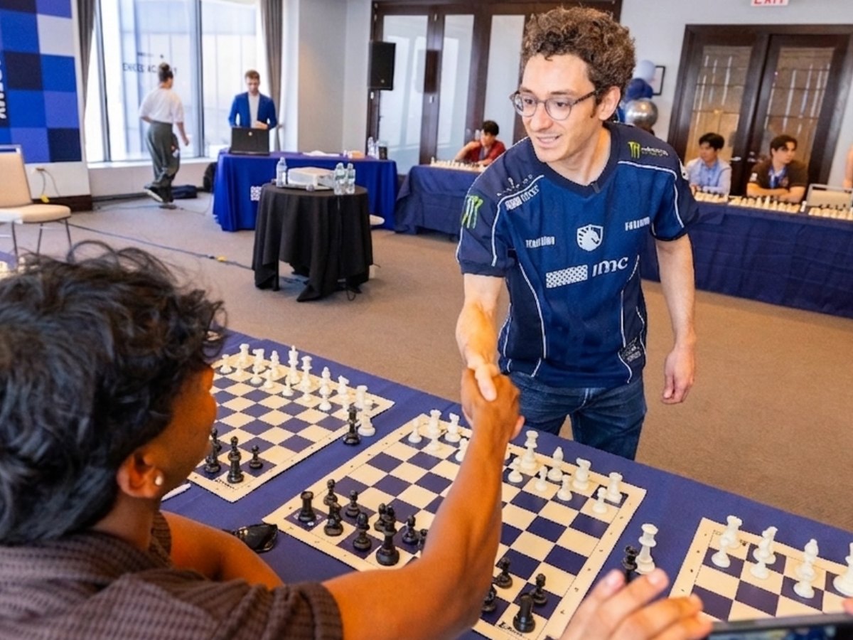 Aryan Achuthan shaking hands with Fabiano Caruana at the IMC Chess Academy simul in Chicago